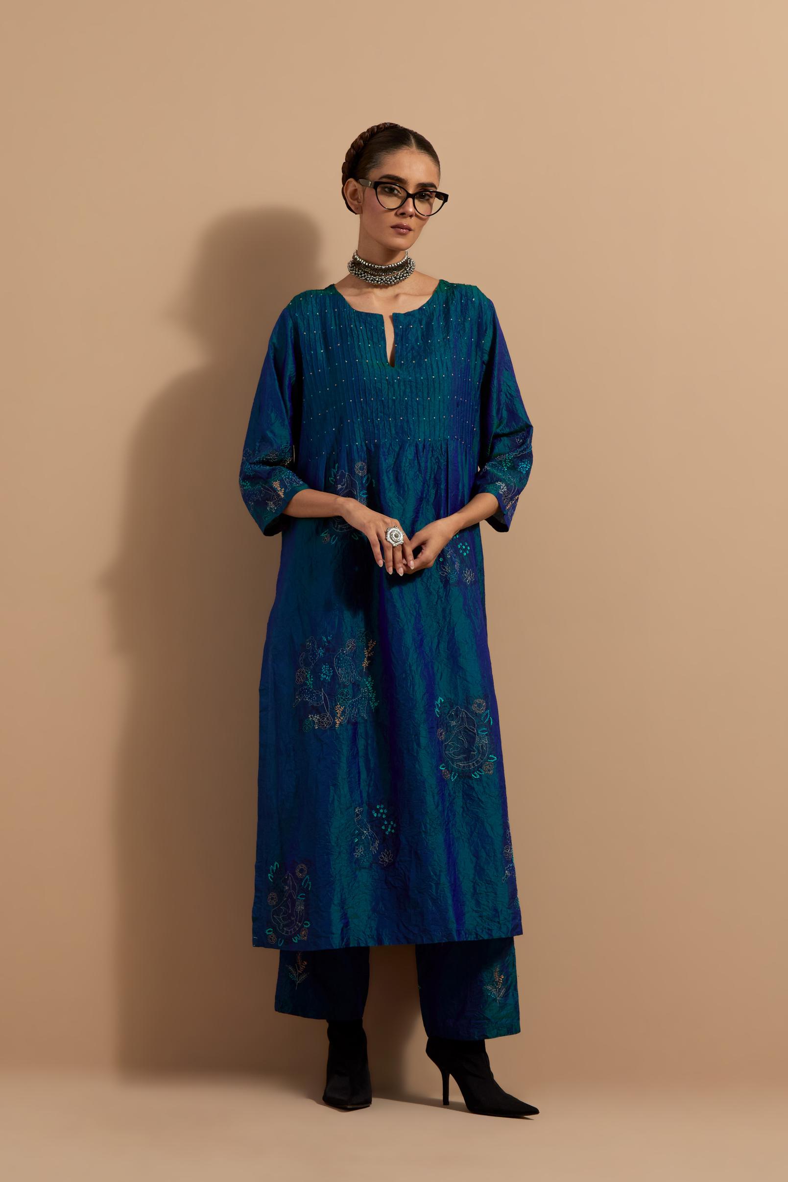 Teal blue crushed silk hand block printed kurta set with pin tucks at yoke, highlighted with multi colored thread embroidery.