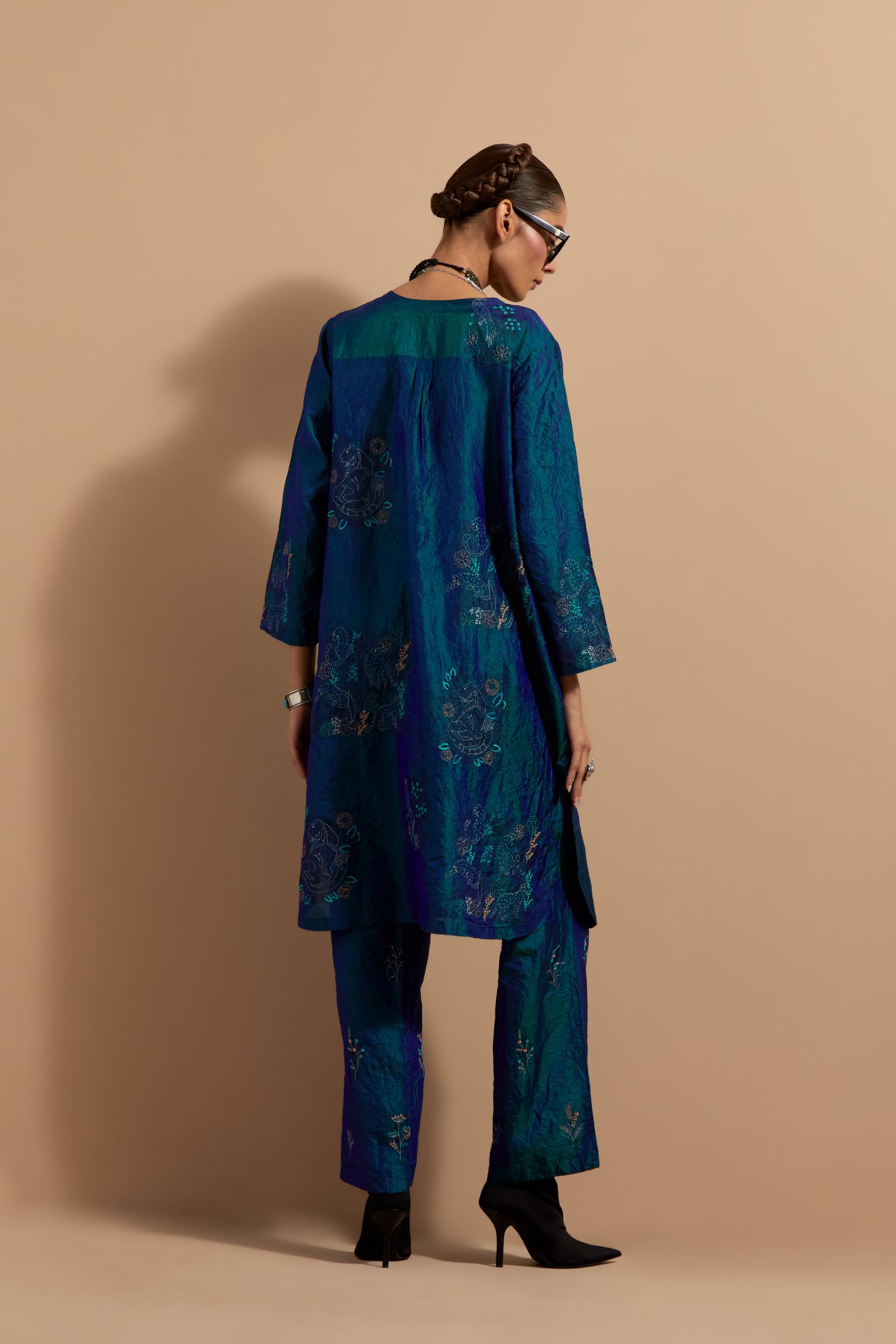 Teal blue crushed silk short kurta set with hand block print, highlighted with multi colored thread embroidery.