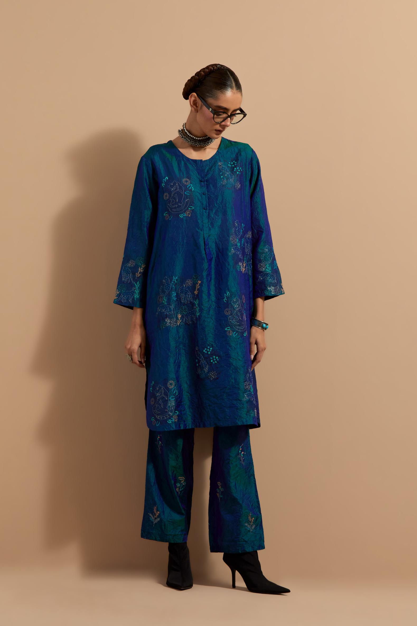 Teal blue crushed silk short kurta set with hand block print, highlighted with multi colored thread embroidery.