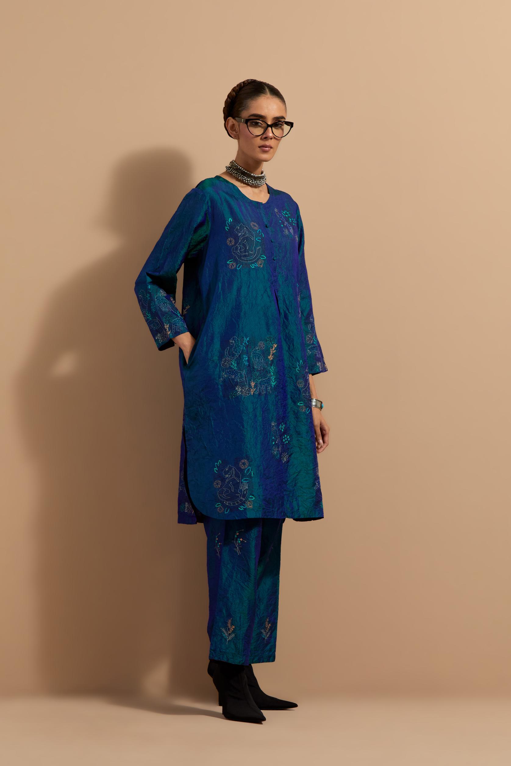 Teal blue crushed silk short kurta set with hand block print, highlighted with multi colored thread embroidery.