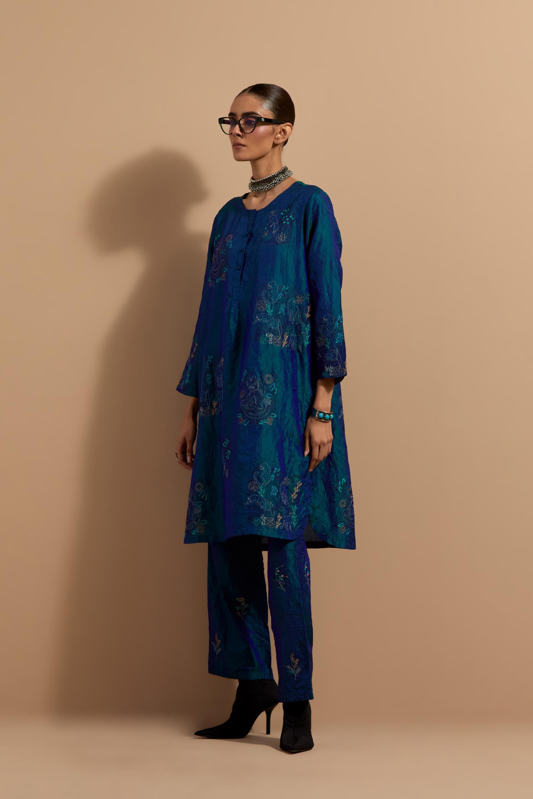 Teal blue crushed silk short kurta set with hand block print, highlighted with multi colored thread embroidery.