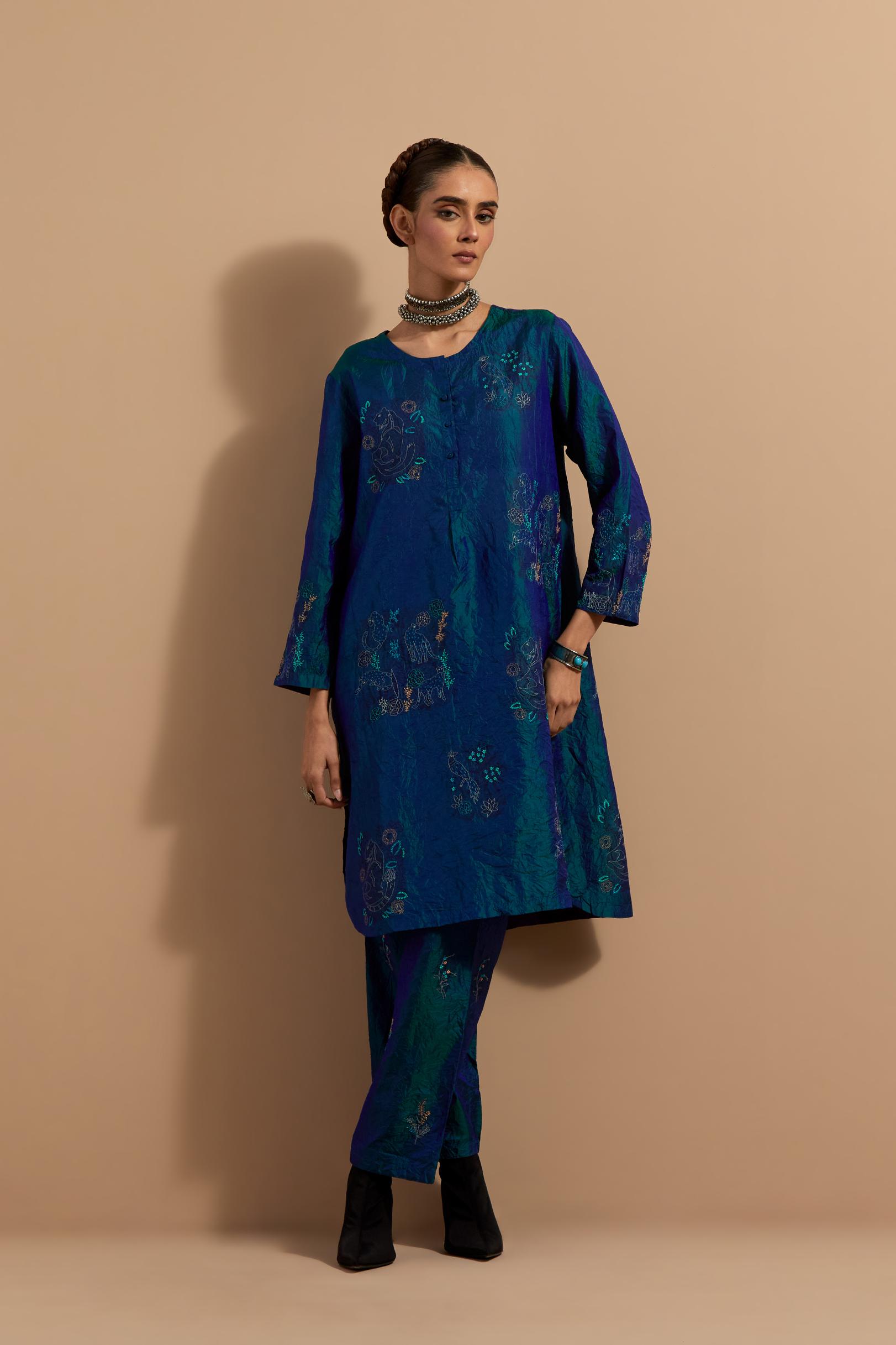 Teal blue crushed silk short kurta set with hand block print, highlighted with multi colored thread embroidery.