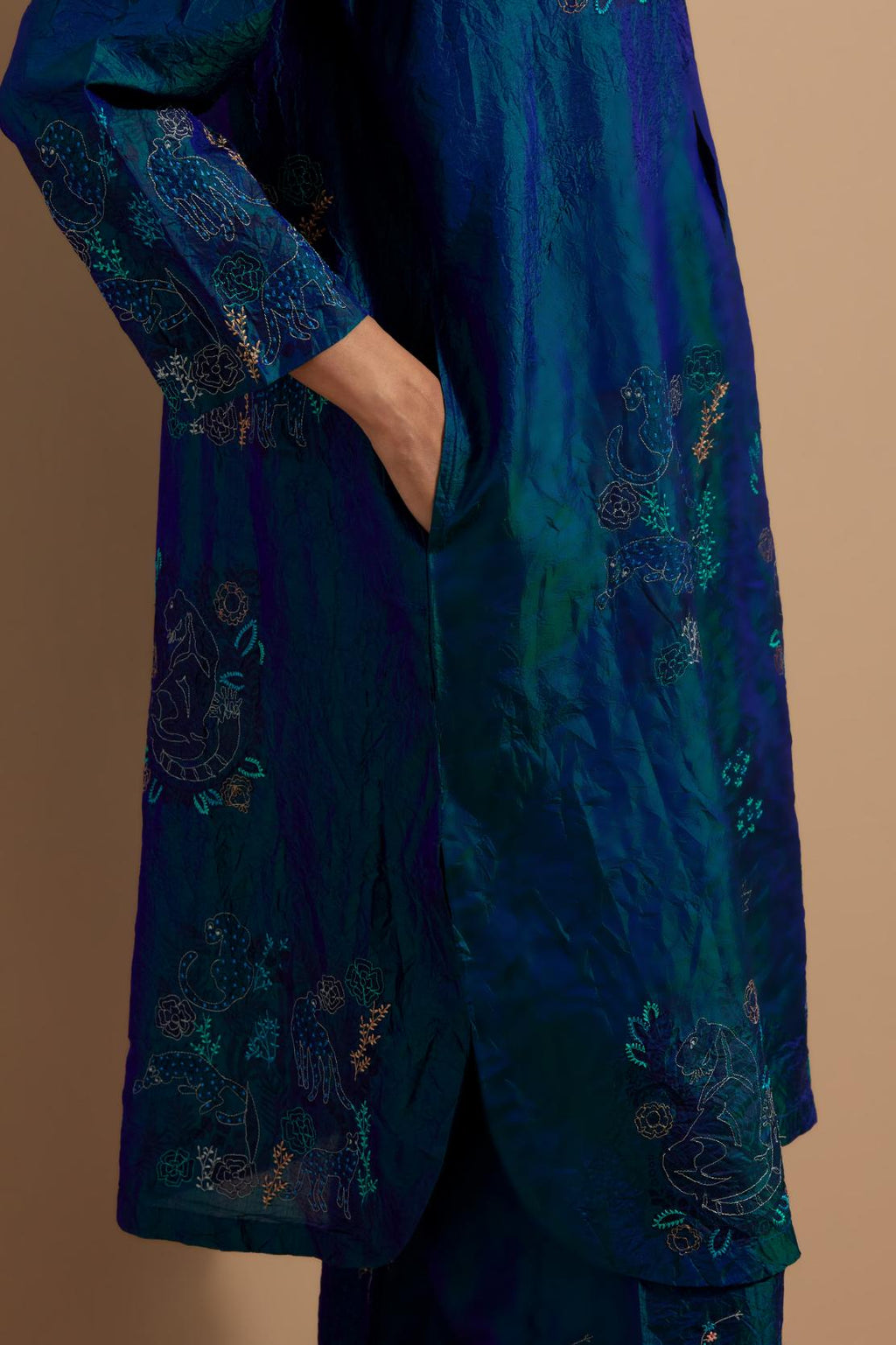 Teal blue crushed silk short kurta set with hand block print, highlighted with multi colored thread embroidery.