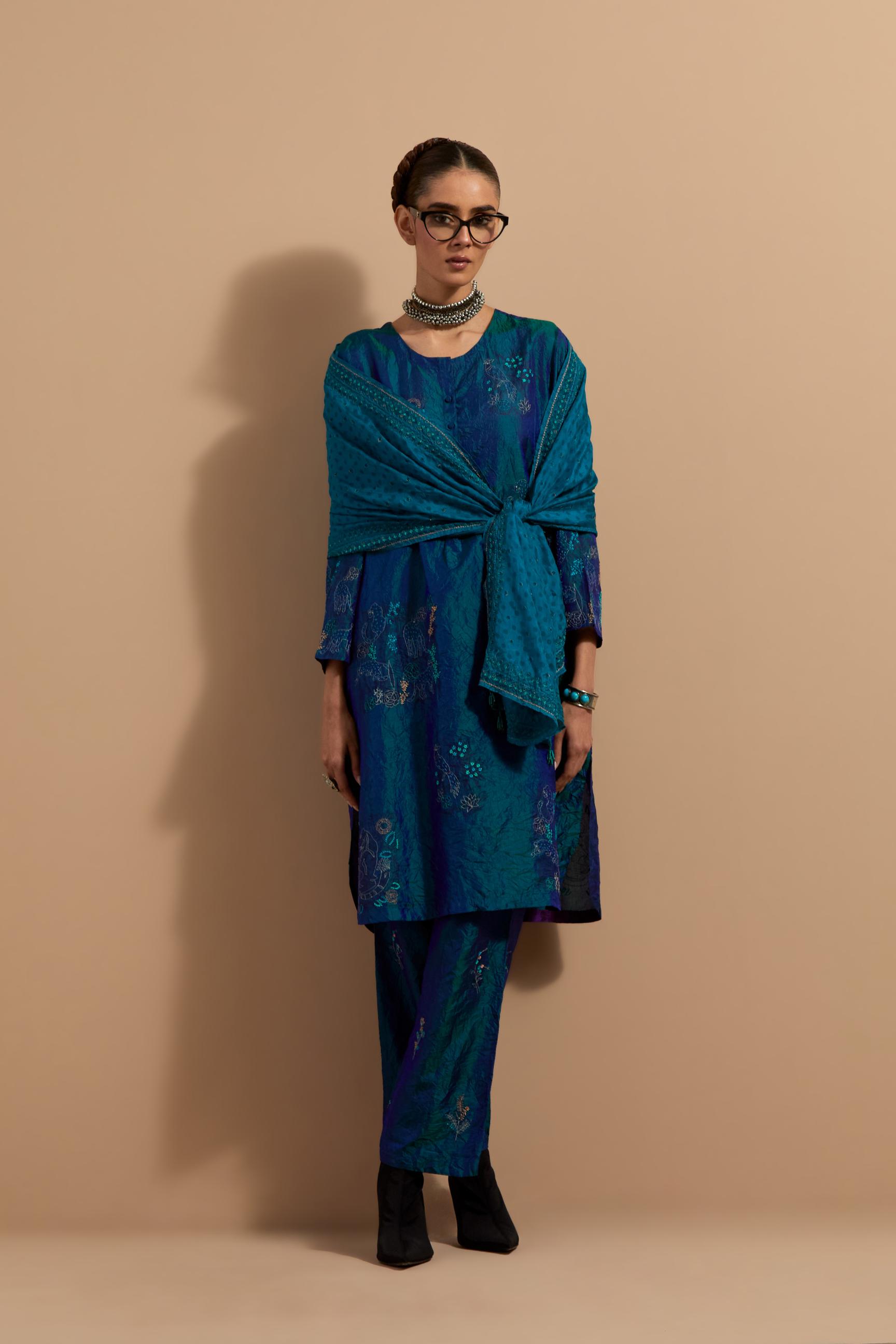 Teal blue crushed silk short kurta set with hand block print, highlighted with multi colored thread embroidery.