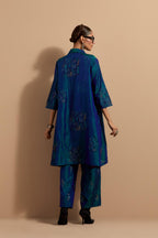 Teal blue crushed silk A-line short kurta set with hand block print, highlighted with multi colored thread embroidery.