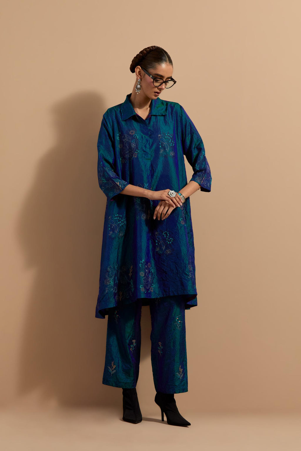 Teal blue crushed silk A-line short kurta set with hand block print, highlighted with multi colored thread embroidery.
