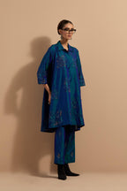 Teal blue crushed silk A-line short kurta set with hand block print, highlighted with multi colored thread embroidery.
