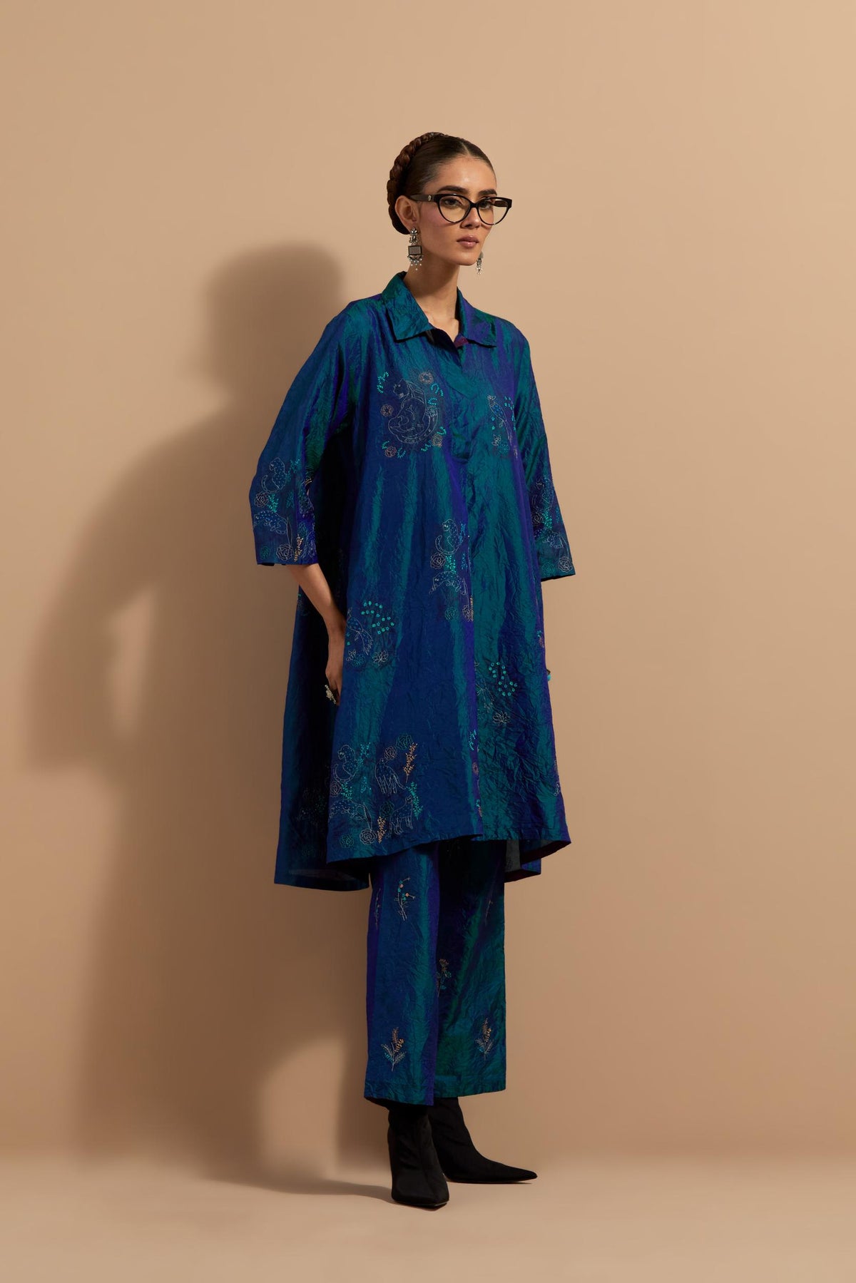 Teal blue crushed silk A-line short kurta set with hand block print, highlighted with multi colored thread embroidery.