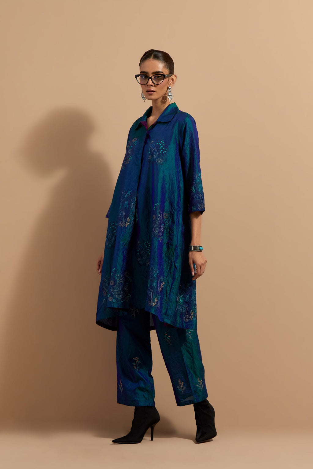 Teal blue crushed silk A-line short kurta set with hand block print, highlighted with multi colored thread embroidery.