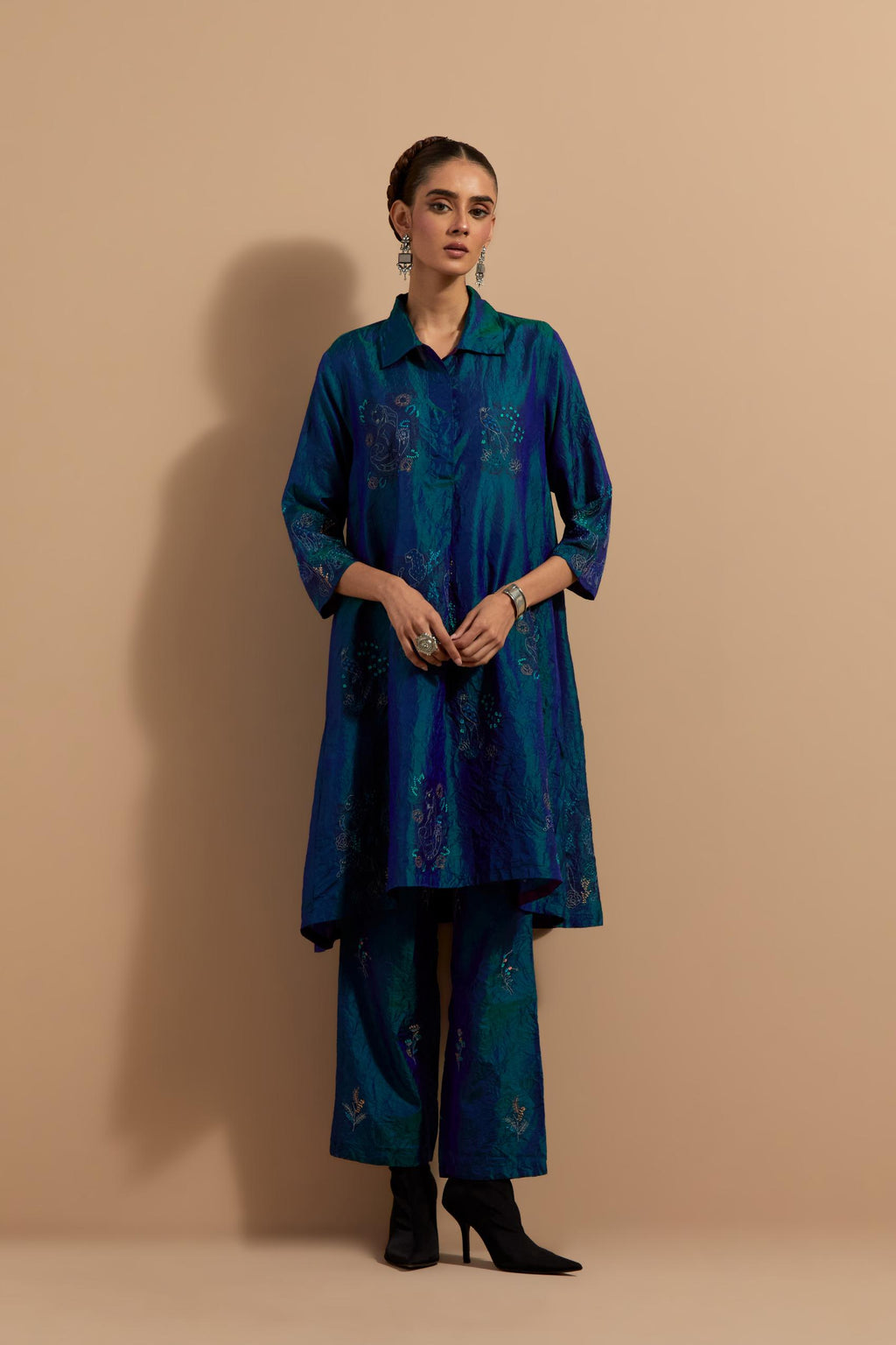 Teal blue crushed silk A-line short kurta set with hand block print, highlighted with multi colored thread embroidery.