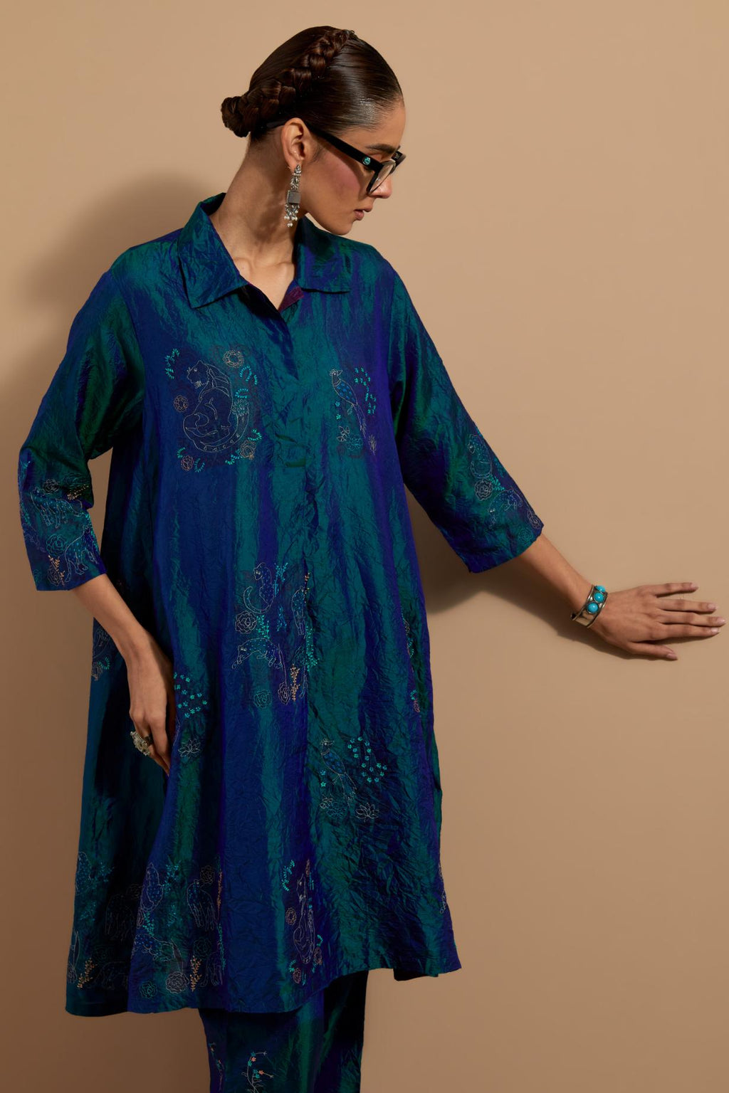 Teal blue crushed silk A-line short kurta set with hand block print, highlighted with multi colored thread embroidery.
