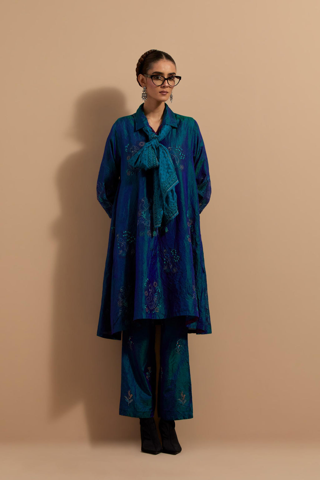 Teal blue crushed silk A-line short kurta set with hand block print, highlighted with multi colored thread embroidery.