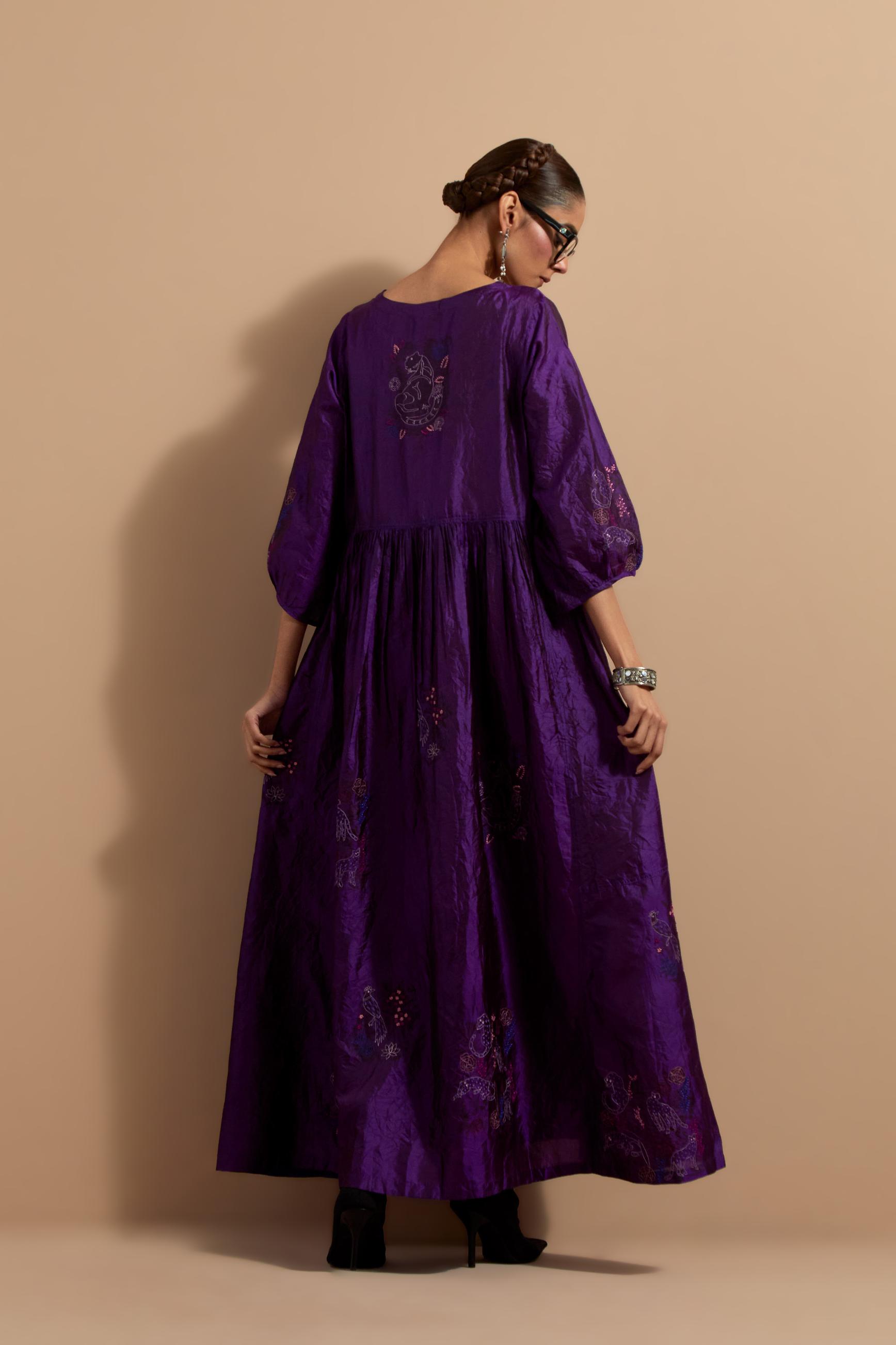 Purple crushed silk hand block printed long dress, highlighted with multi colored thread embroidery, paired with Mauve hand crushed block printed silk stole with quilted embroidery and beaded tassels.