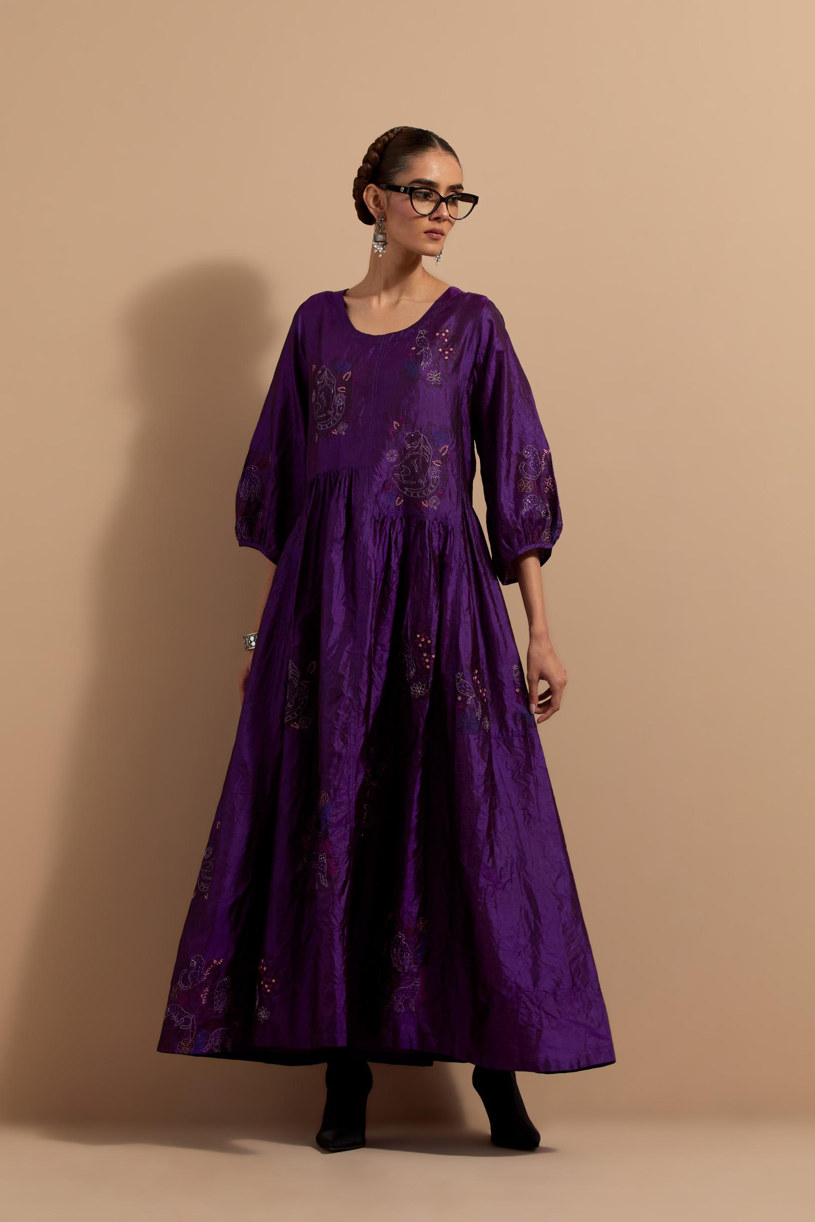 Purple crushed silk hand block printed long dress, highlighted with multi colored thread embroidery, paired with Mauve hand crushed block printed silk stole with quilted embroidery and beaded tassels.