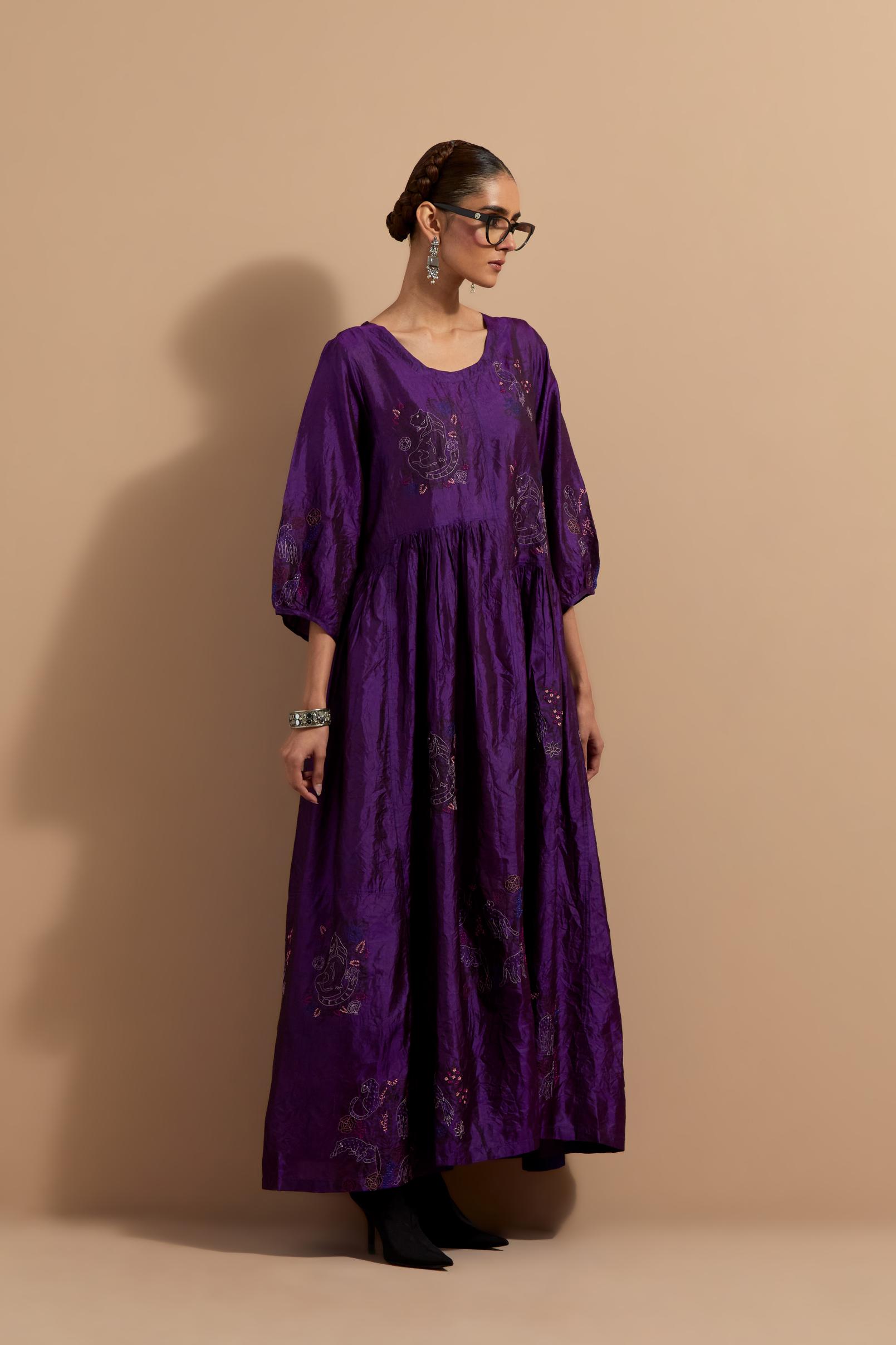 Purple crushed silk hand block printed long dress, highlighted with multi colored thread embroidery, paired with Mauve hand crushed block printed silk stole with quilted embroidery and beaded tassels.