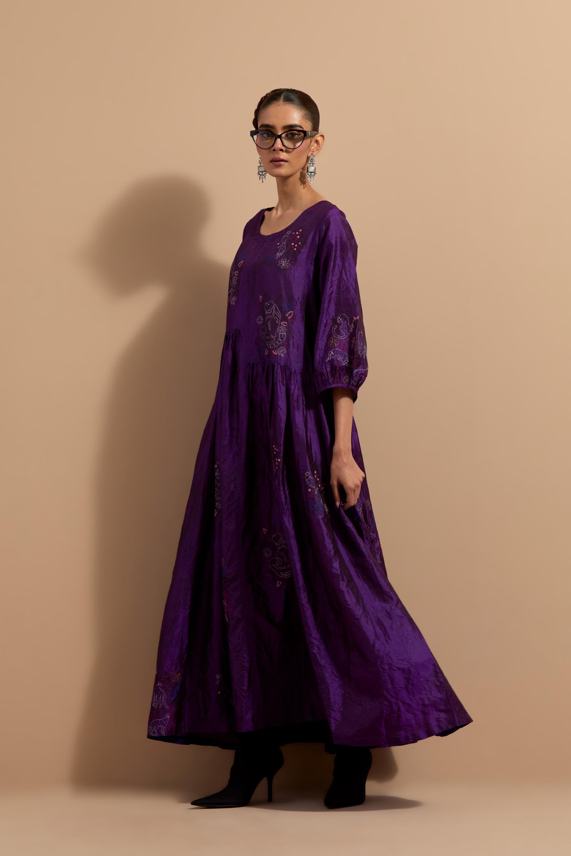 Purple crushed silk hand block printed long dress, highlighted with multi colored thread embroidery, paired with Mauve hand crushed block printed silk stole with quilted embroidery and beaded tassels.