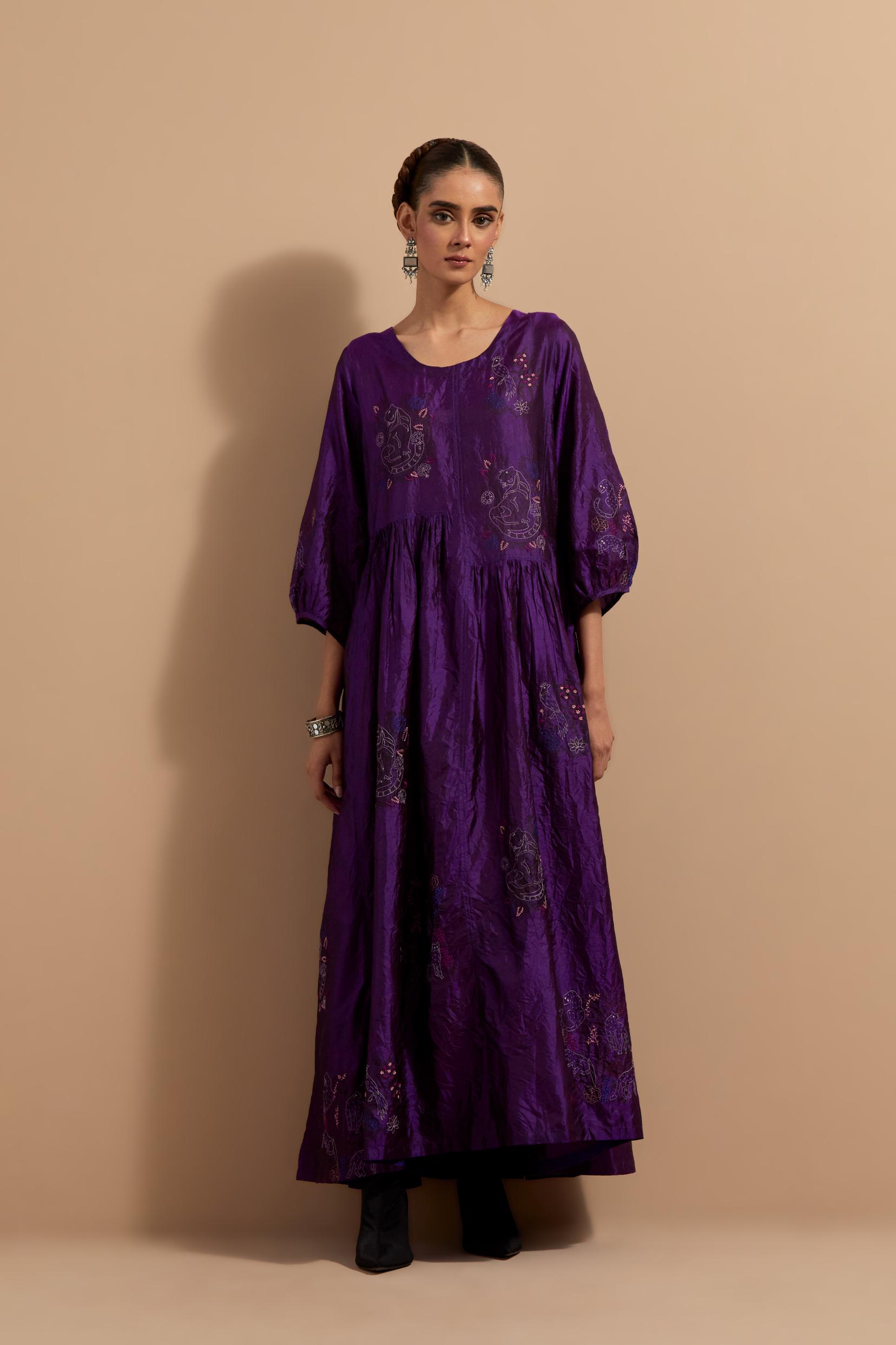 Purple crushed silk hand block printed long dress, highlighted with multi colored thread embroidery, paired with Mauve hand crushed block printed silk stole with quilted embroidery and beaded tassels.