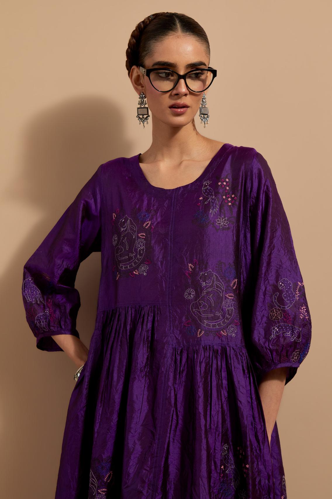 Purple crushed silk hand block printed long dress, highlighted with multi colored thread embroidery, paired with Mauve hand crushed block printed silk stole with quilted embroidery and beaded tassels.