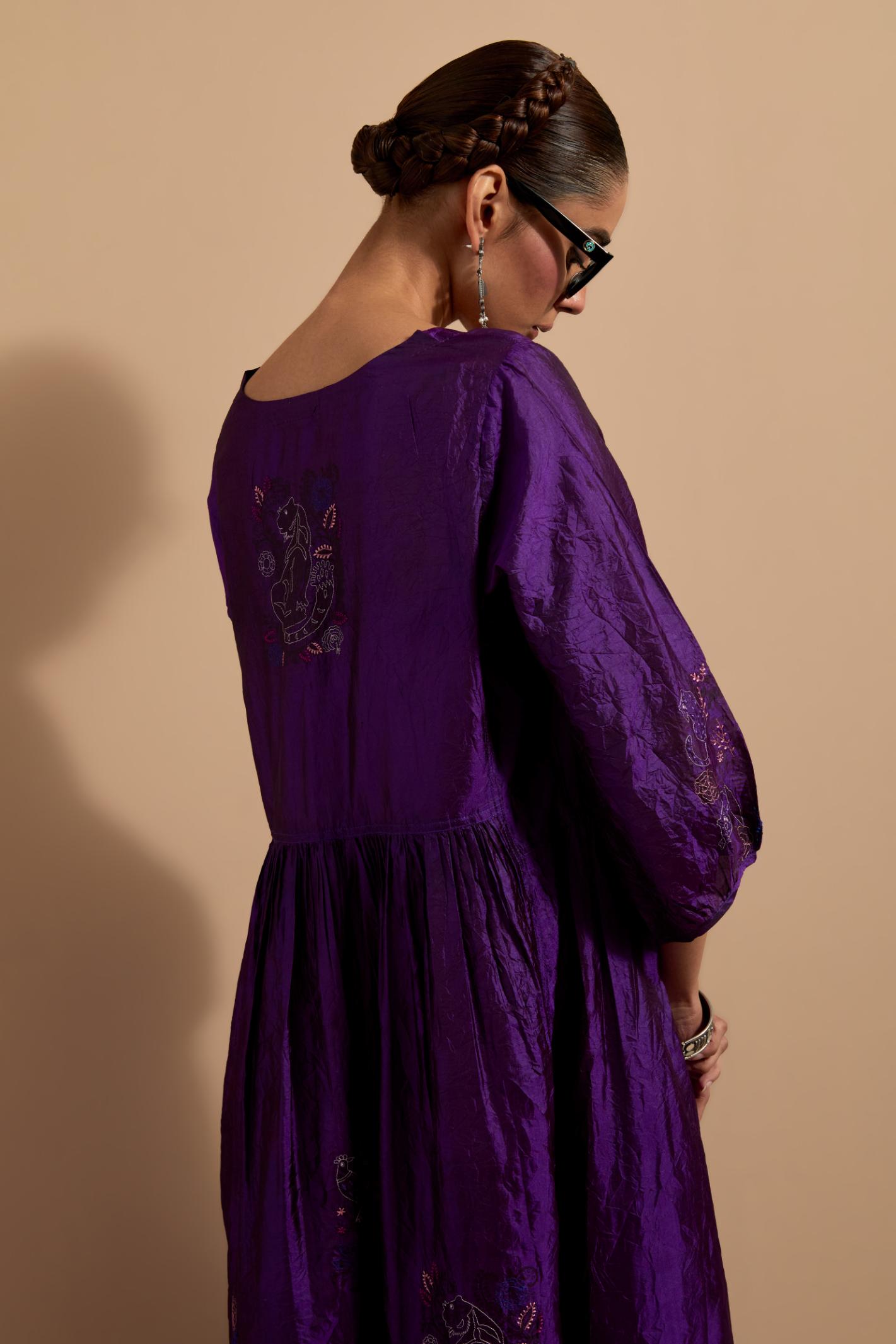 Purple crushed silk hand block printed long dress, highlighted with multi colored thread embroidery, paired with Mauve hand crushed block printed silk stole with quilted embroidery and beaded tassels.