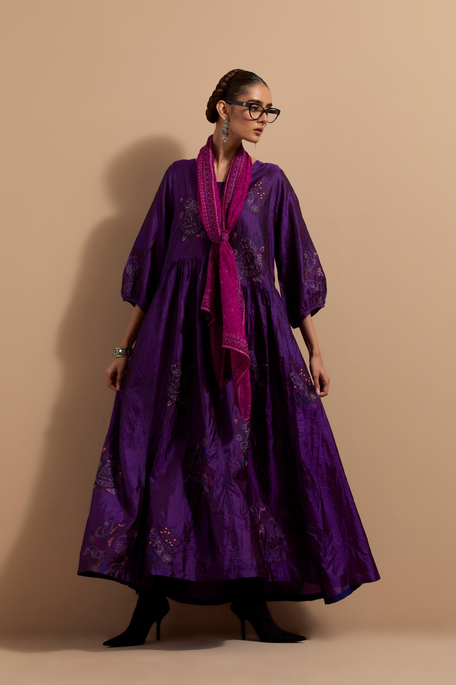 Purple crushed silk hand block printed long dress, highlighted with multi colored thread embroidery, paired with Mauve hand crushed block printed silk stole with quilted embroidery and beaded tassels.