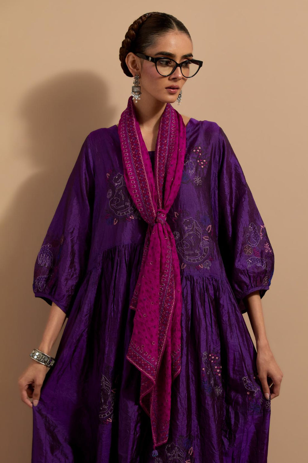 Purple crushed silk hand block printed long dress, highlighted with multi colored thread embroidery, paired with Mauve hand crushed block printed silk stole with quilted embroidery and beaded tassels.