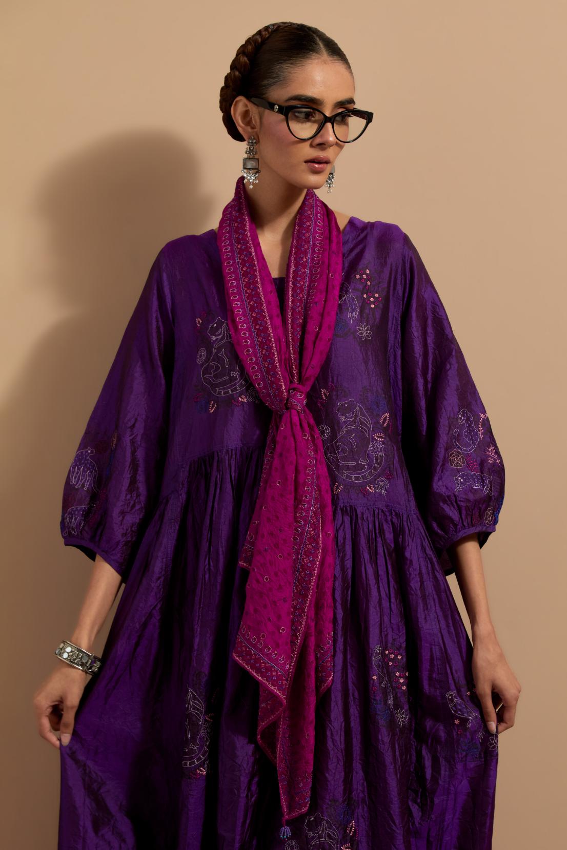 Purple crushed silk hand block printed long dress, highlighted with multi colored thread embroidery, paired with Mauve hand crushed block printed silk stole with quilted embroidery and beaded tassels.