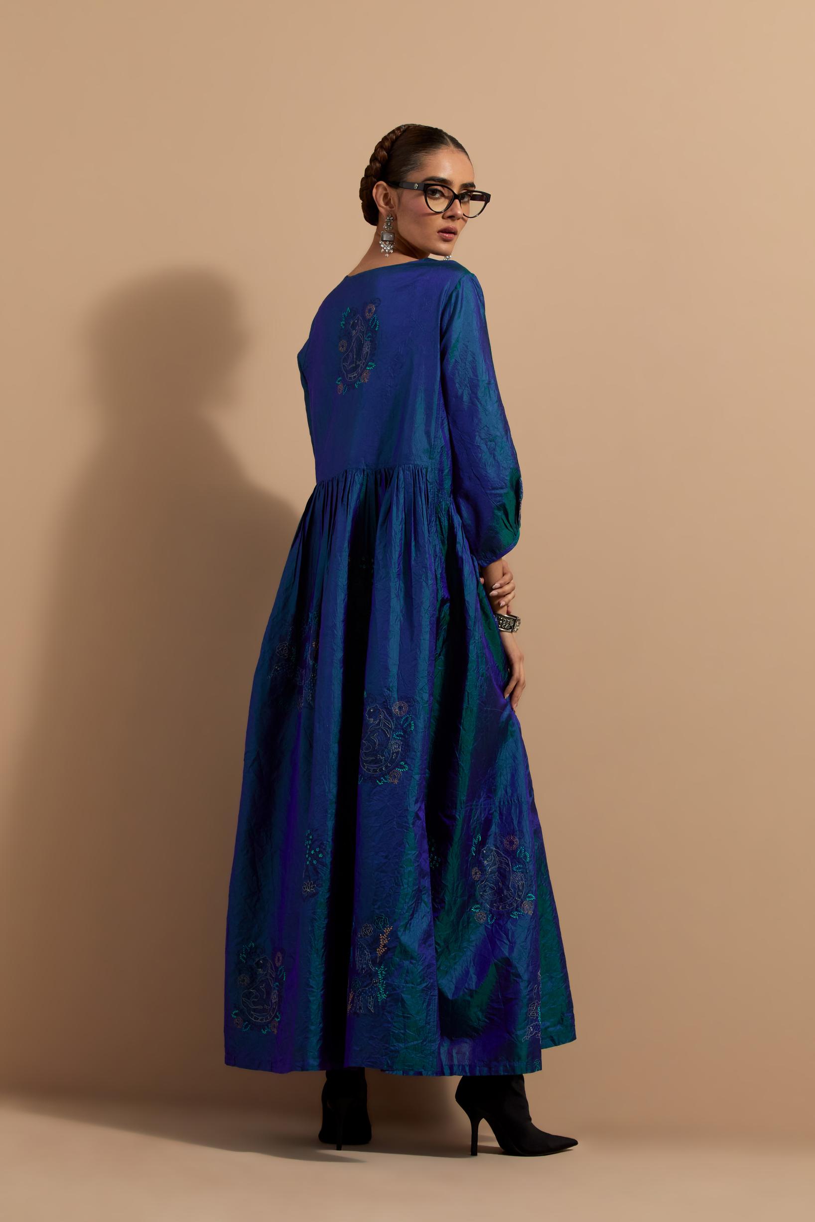 Teal blue crushed silk hand block printed long dress, highlighted with multi colored thread embroidery, paired with Mauve hand crushed block printed silk stole with quilted embroidery and beaded tassels.