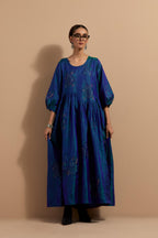 Teal blue crushed silk hand block printed long dress, highlighted with multi colored thread embroidery, paired with Mauve hand crushed block printed silk stole with quilted embroidery and beaded tassels.