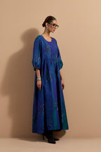 Teal blue crushed silk hand block printed long dress, highlighted with multi colored thread embroidery, paired with Mauve hand crushed block printed silk stole with quilted embroidery and beaded tassels.
