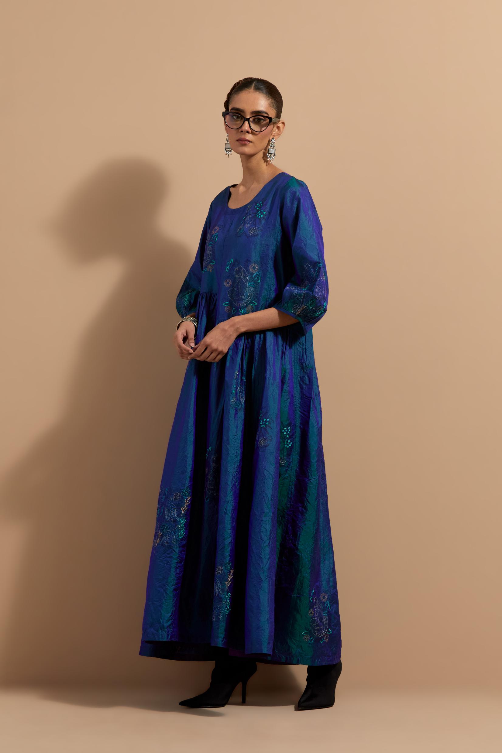 Teal blue crushed silk hand block printed long dress, highlighted with multi colored thread embroidery, paired with Mauve hand crushed block printed silk stole with quilted embroidery and beaded tassels.