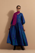 Teal blue crushed silk hand block printed long dress, highlighted with multi colored thread embroidery, paired with Mauve hand crushed block printed silk stole with quilted embroidery and beaded tassels.