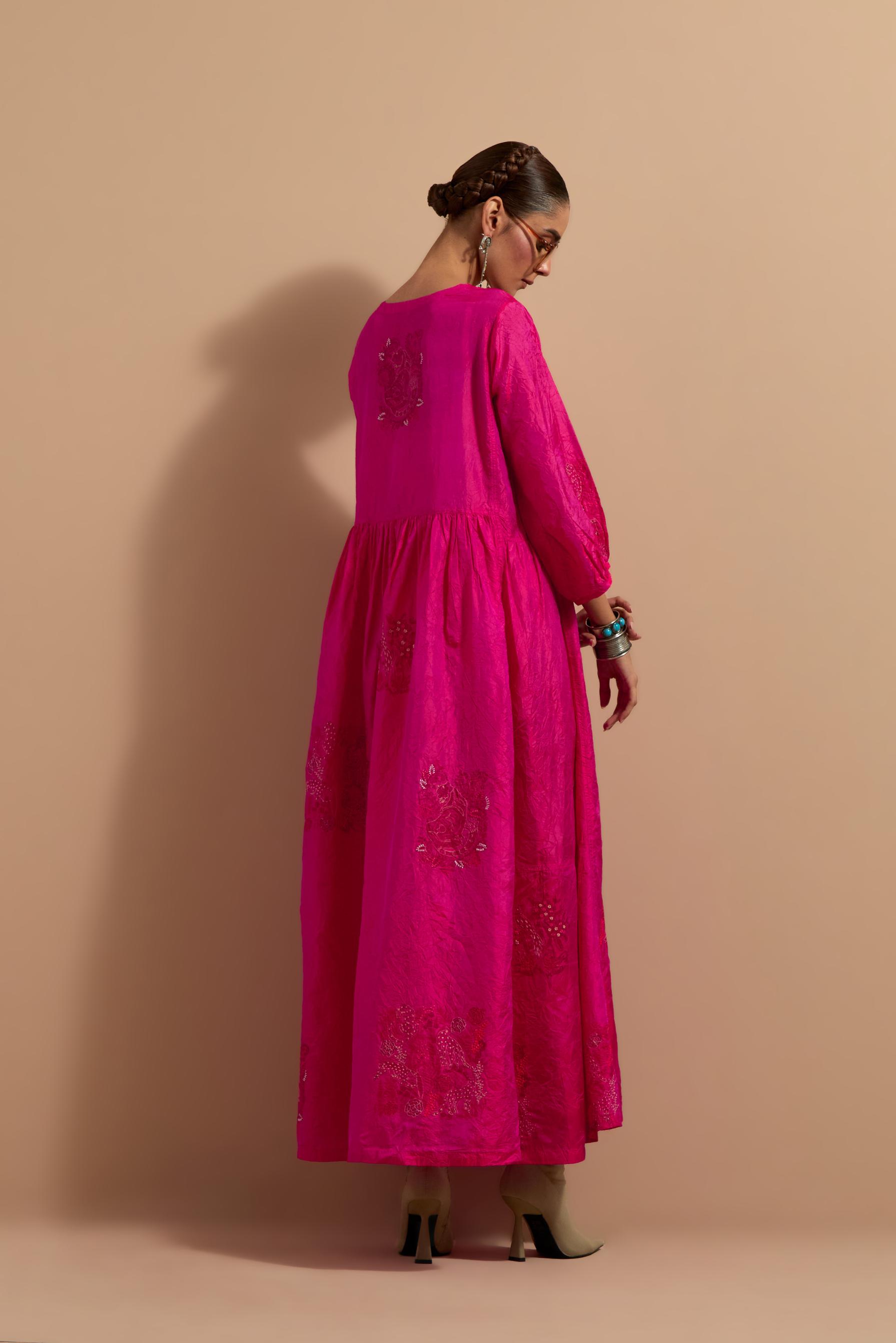 Fuchsia crushed silk hand block printed long dress, highlighted with multi colored thread embroidery, paired with Mauve hand crushed block printed silk stole with quilted embroidery and beaded tassels.