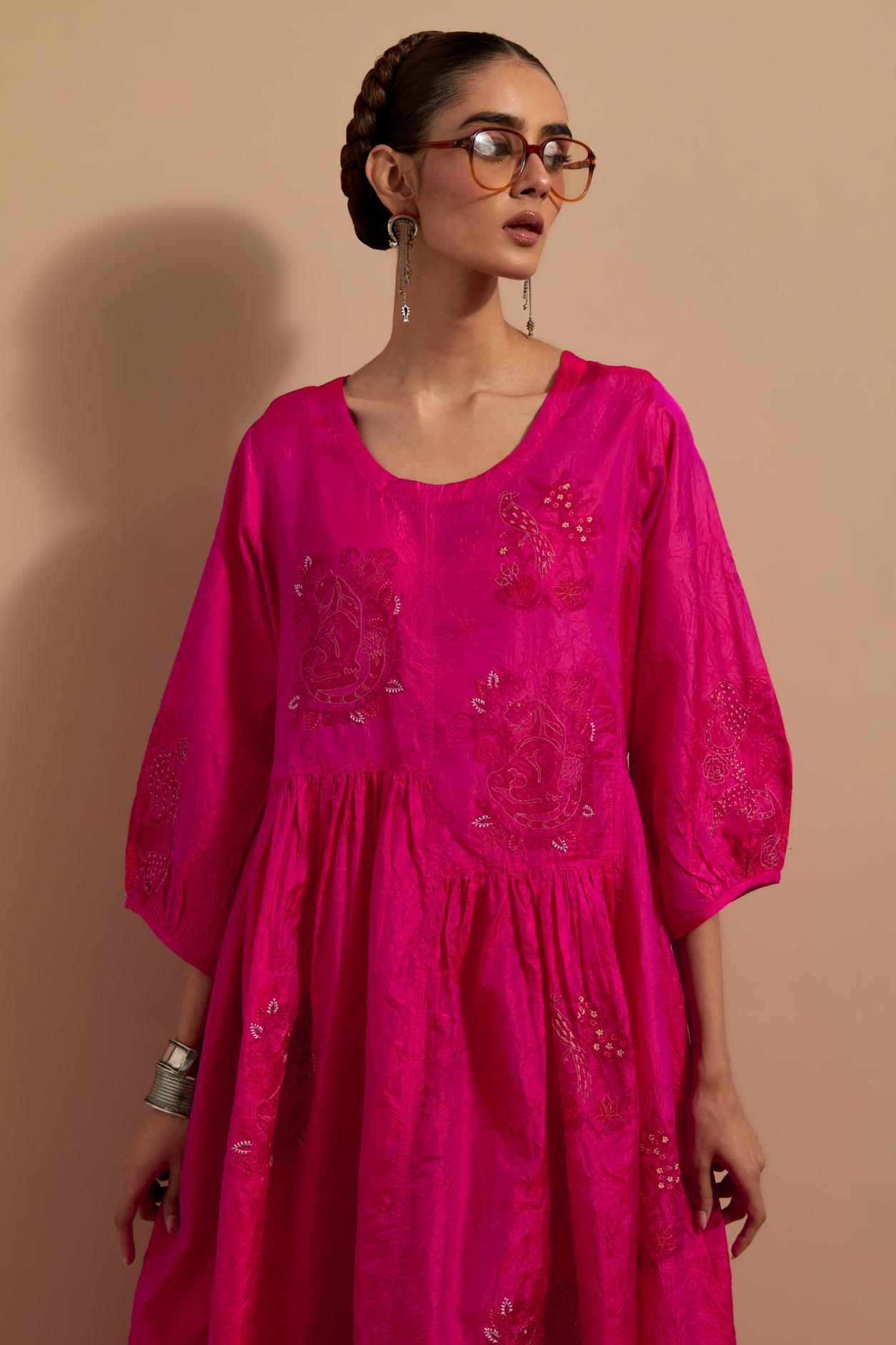 Fuchsia crushed silk hand block printed long dress, highlighted with multi colored thread embroidery, paired with Mauve hand crushed block printed silk stole with quilted embroidery and beaded tassels.