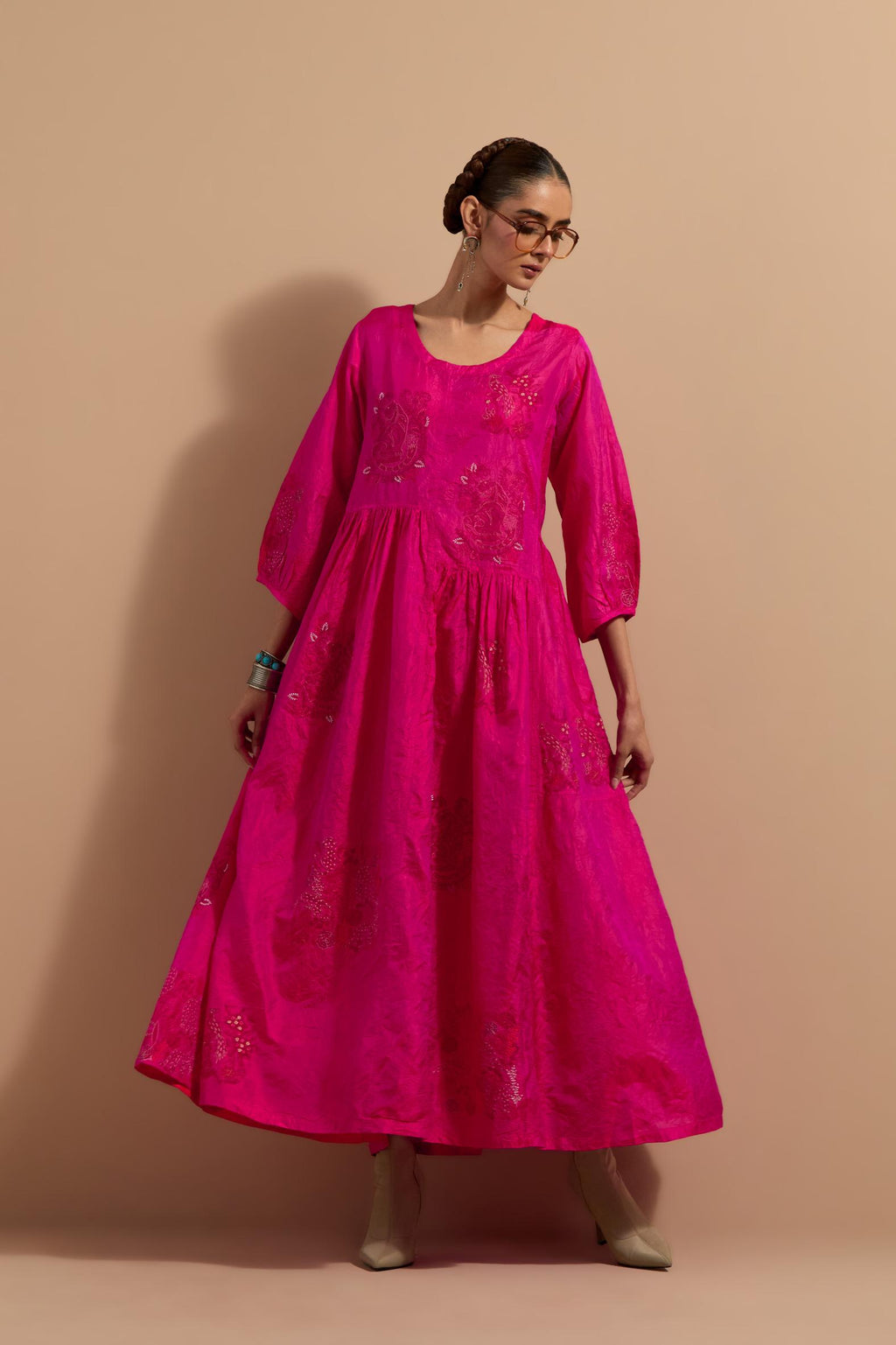 Fuchsia crushed silk hand block printed long dress, highlighted with multi colored thread embroidery, paired with Mauve hand crushed block printed silk stole with quilted embroidery and beaded tassels.