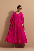 Fuchsia crushed silk hand block printed long dress, highlighted with multi colored thread embroidery, paired with Mauve hand crushed block printed silk stole with quilted embroidery and beaded tassels.