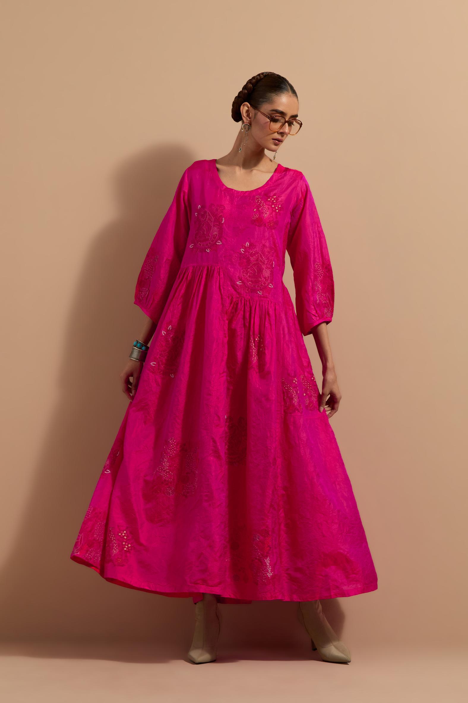 Fuchsia crushed silk hand block printed long dress, highlighted with multi colored thread embroidery, paired with Mauve hand crushed block printed silk stole with quilted embroidery and beaded tassels.