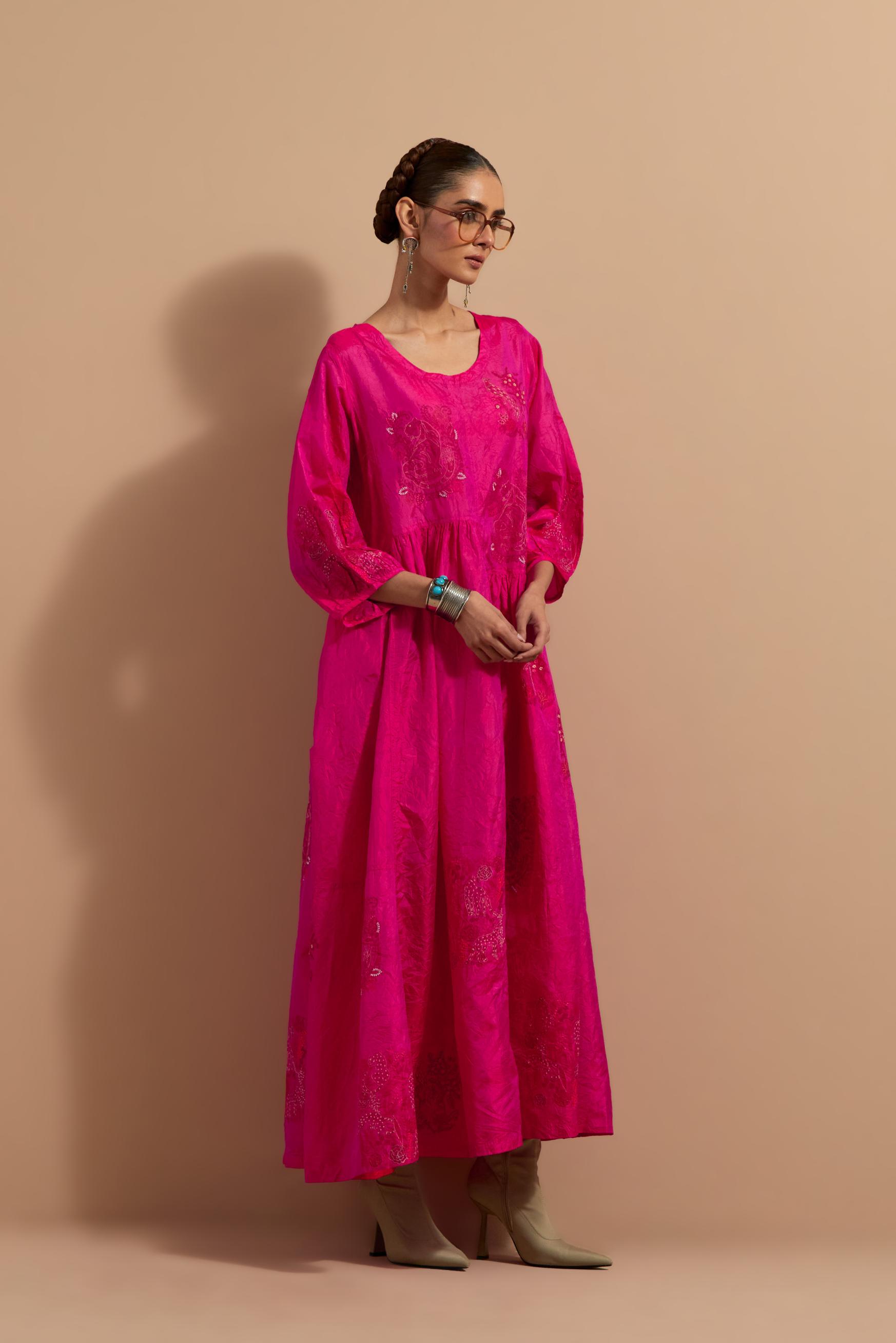 Fuchsia crushed silk hand block printed long dress, highlighted with multi colored thread embroidery, paired with Mauve hand crushed block printed silk stole with quilted embroidery and beaded tassels.