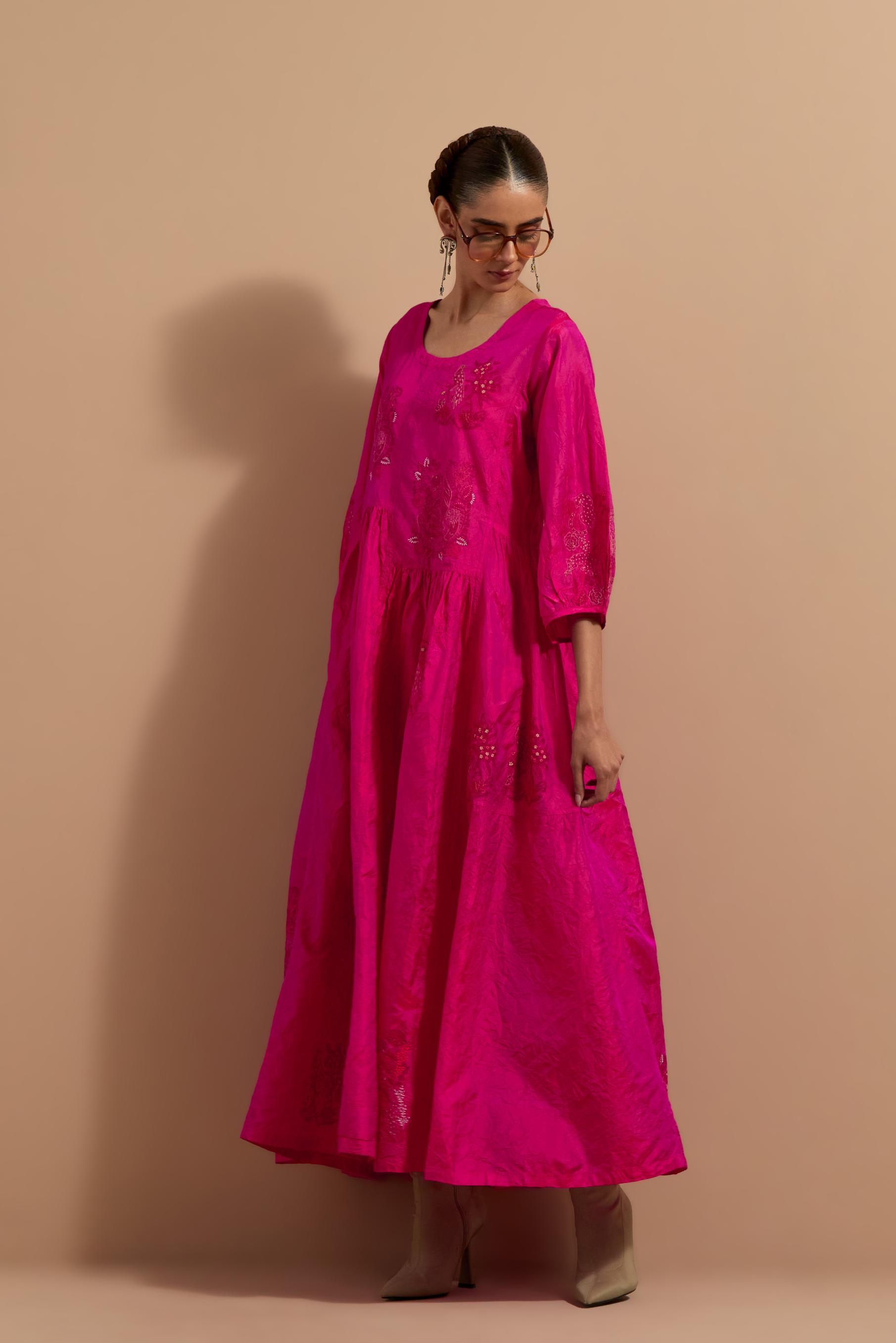 Fuchsia crushed silk hand block printed long dress, highlighted with multi colored thread embroidery, paired with Mauve hand crushed block printed silk stole with quilted embroidery and beaded tassels.