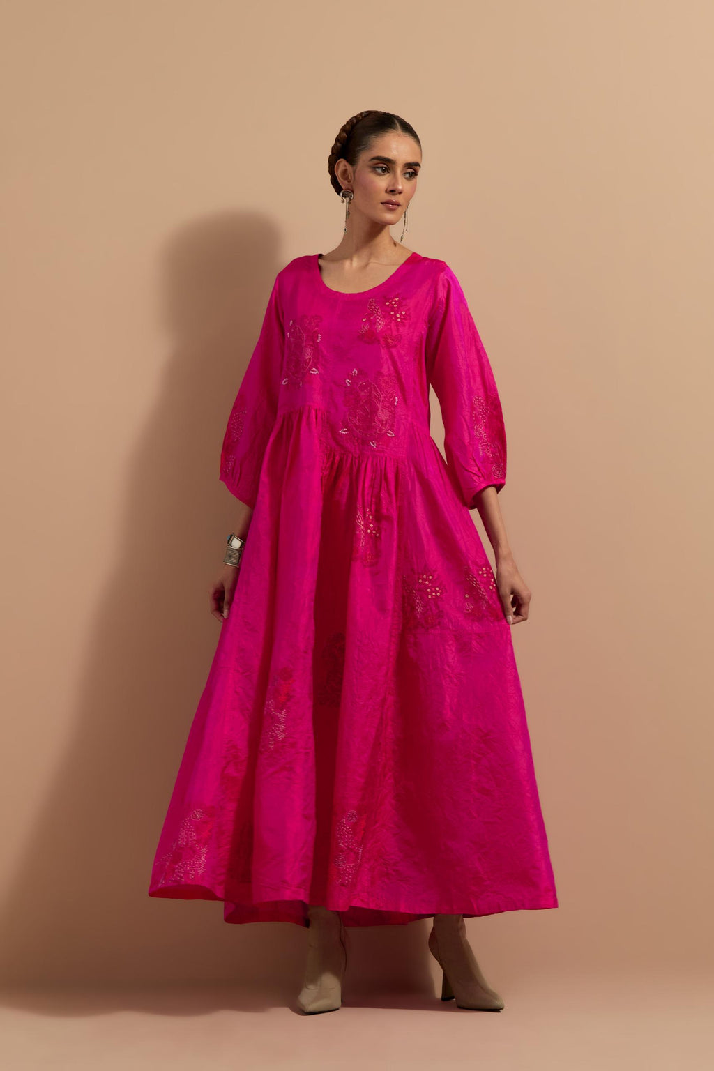 Fuchsia crushed silk hand block printed long dress, highlighted with multi colored thread embroidery, paired with Mauve hand crushed block printed silk stole with quilted embroidery and beaded tassels.