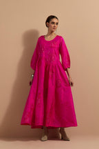 Fuchsia crushed silk hand block printed long dress, highlighted with multi colored thread embroidery, paired with Mauve hand crushed block printed silk stole with quilted embroidery and beaded tassels.
