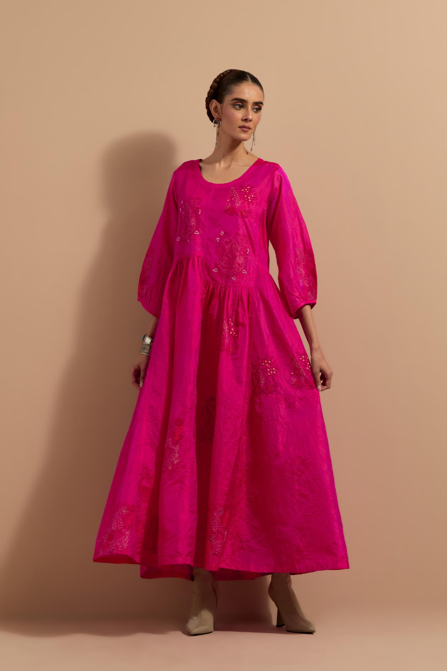Fuchsia crushed silk hand block printed long dress, highlighted with multi colored thread embroidery, paired with Mauve hand crushed block printed silk stole with quilted embroidery and beaded tassels.