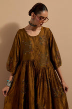 Olive crushed silk hand block printed long dress, highlighted with multi colored thread embroidery, paired with Purple hand crushed block printed silk stole with quilted embroidery and beaded tassels.