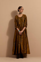 Olive crushed silk hand block printed long dress, highlighted with multi colored thread embroidery, paired with Purple hand crushed block printed silk stole with quilted embroidery and beaded tassels.