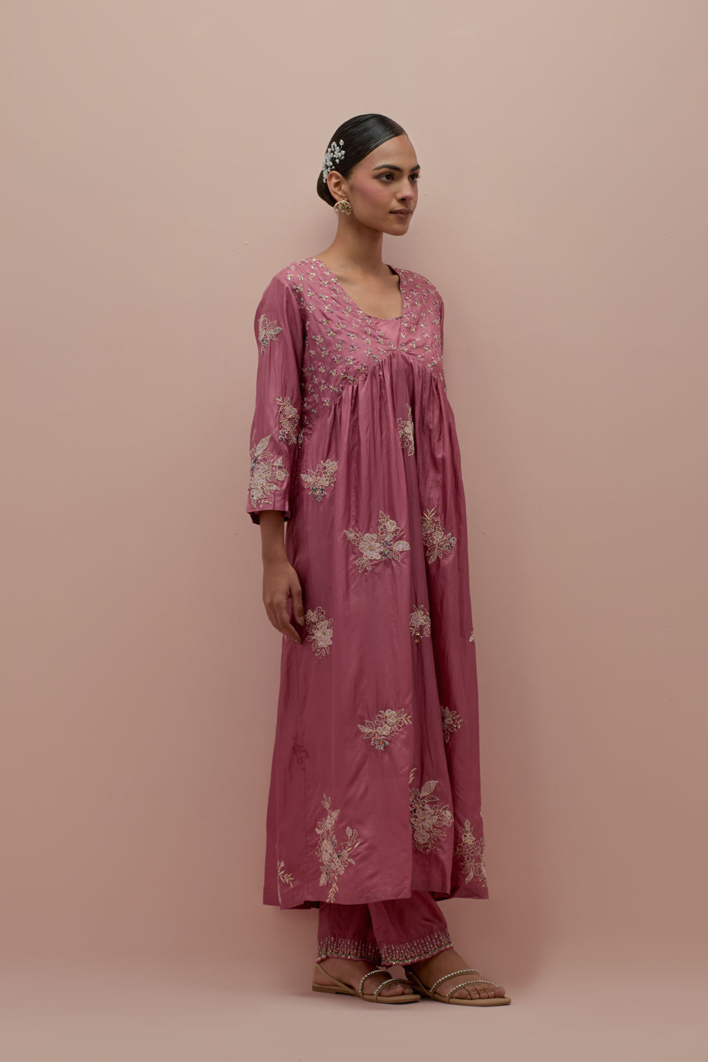 Salmon pink silk kurta dress set with delicate embroidered flowers and hand block printed appliqué motifs, highlighted with sequins and multi-colored beads.