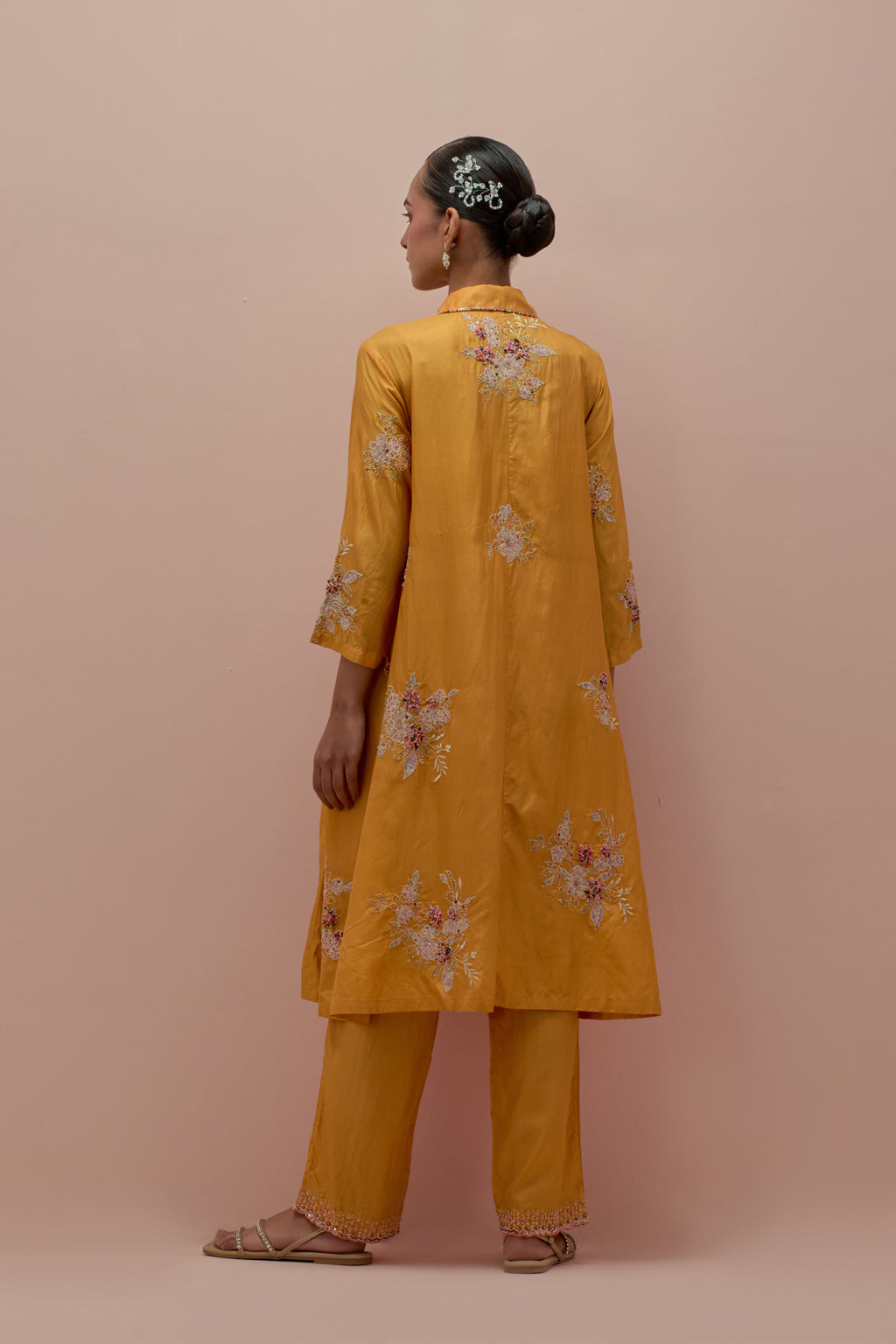 Amber silk short shirt-kurta set with all-over appliqué flowers, highlighted with sequins and multi-colored beads.