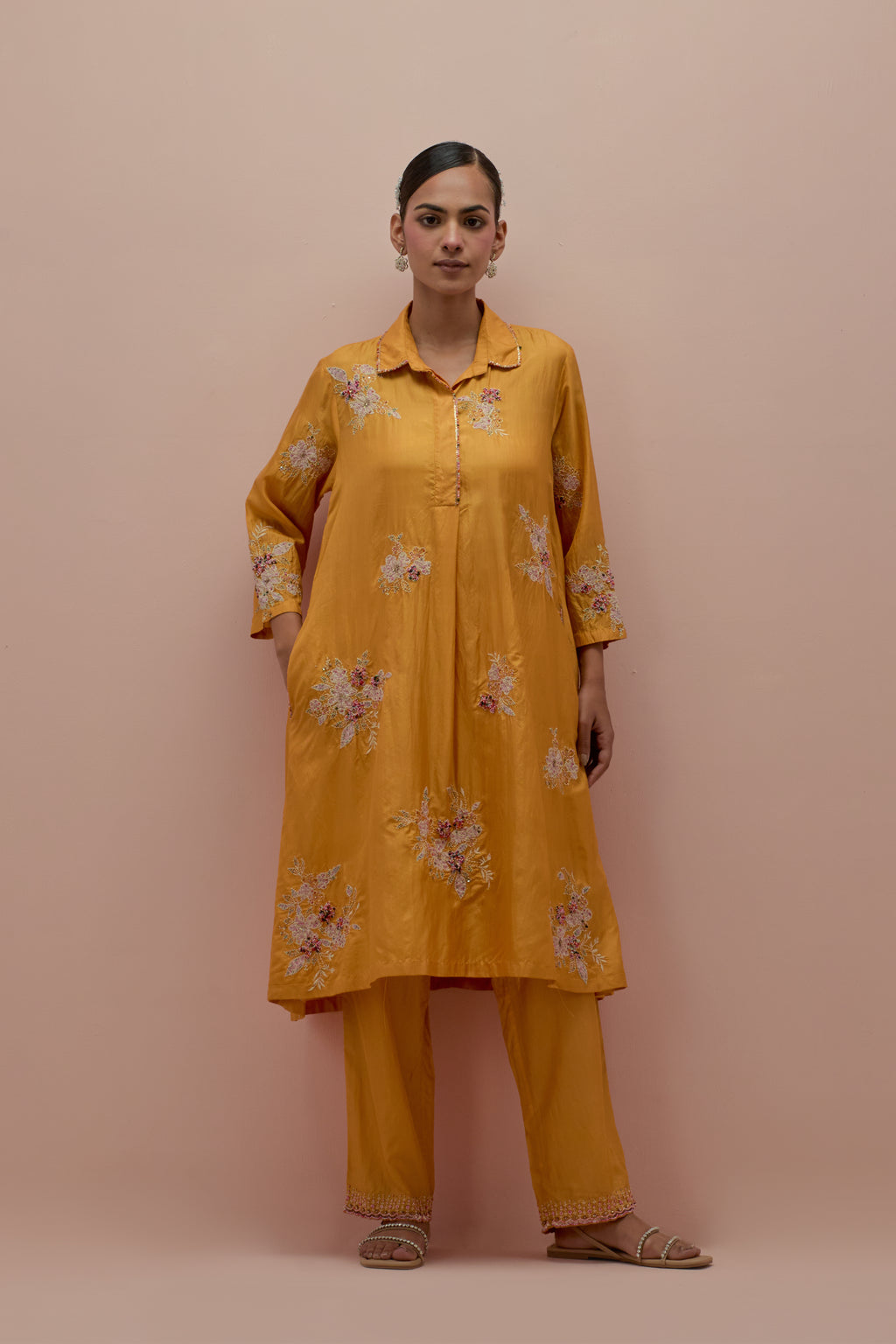 Amber silk short shirt-kurta set with all-over appliqué flowers, highlighted with sequins and multi-colored beads.