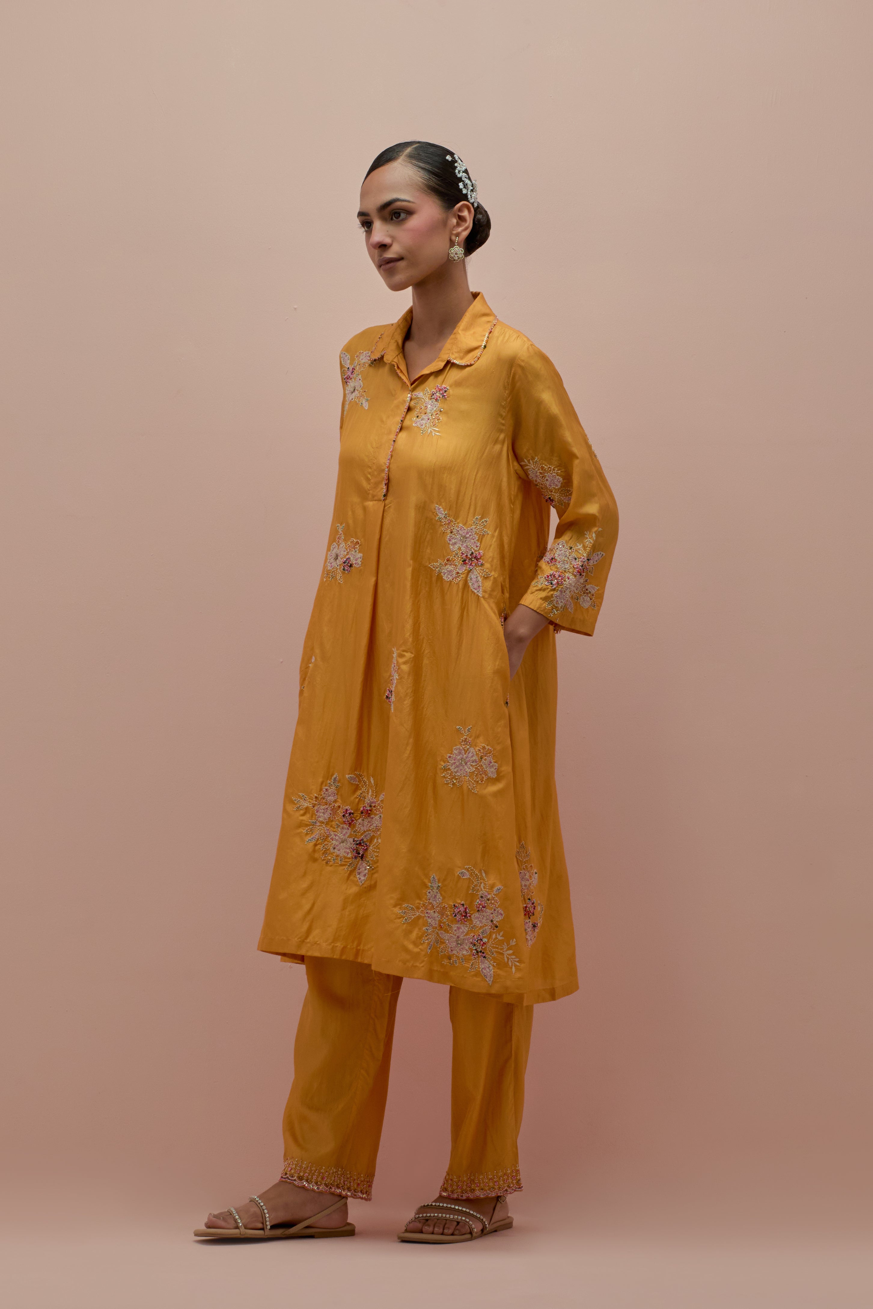 Amber silk short shirt-kurta set with all-over appliqué flowers, highlighted with sequins and multi-colored beads.