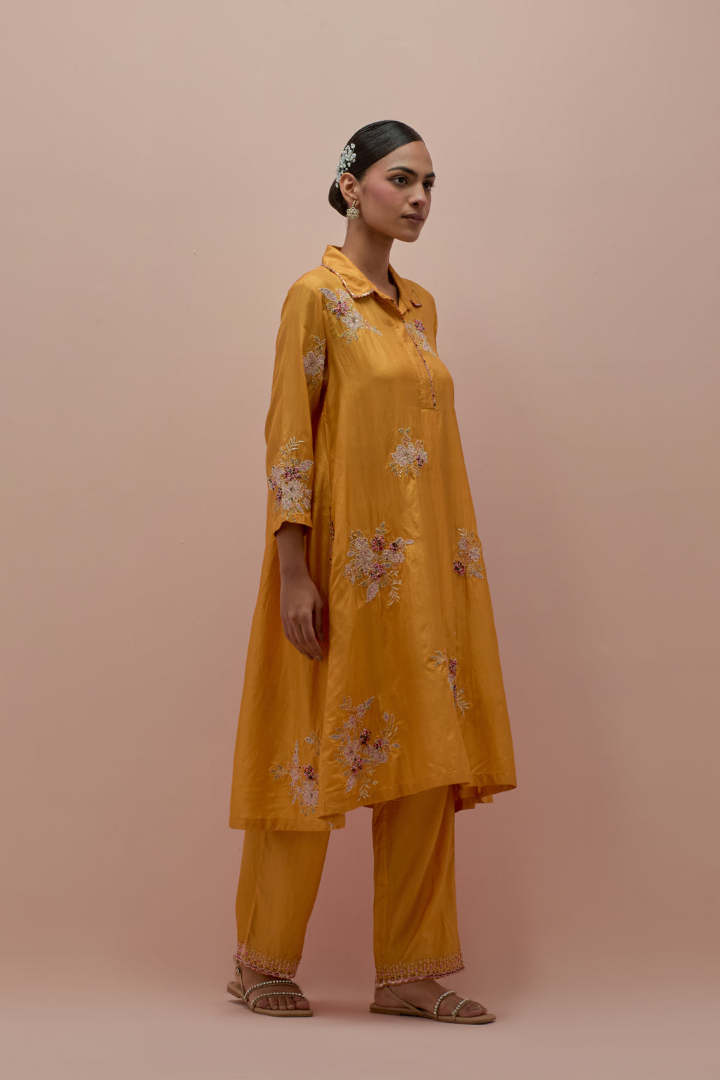 Amber silk short shirt-kurta set with all-over appliqué flowers, highlighted with sequins and multi-colored beads.