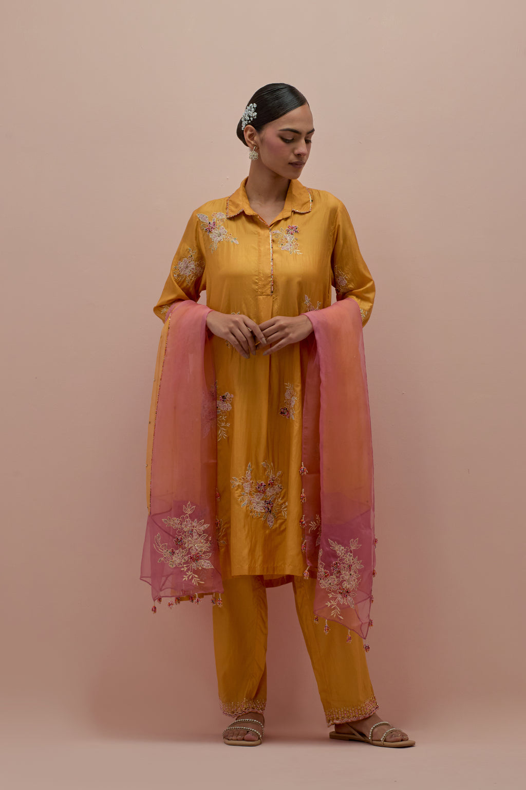 Amber silk short shirt-kurta set with all-over appliqué flowers, highlighted with sequins and multi-colored beads.