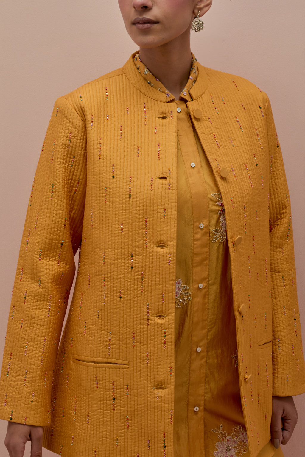 Amber silk, quilted short length front open jacket set with all-over sequins and multicolored beads work.